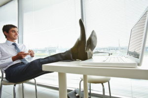 man with feet on desk